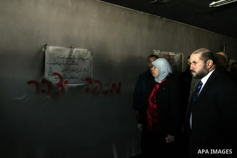 Palestinian women from the West bank village of Burqa near Ramallah, view the damage at the village Al-Nur mosque, on 15 December 2011. The mosque was set on fire during the night allegedly by Israeli settlers and Hebrew...