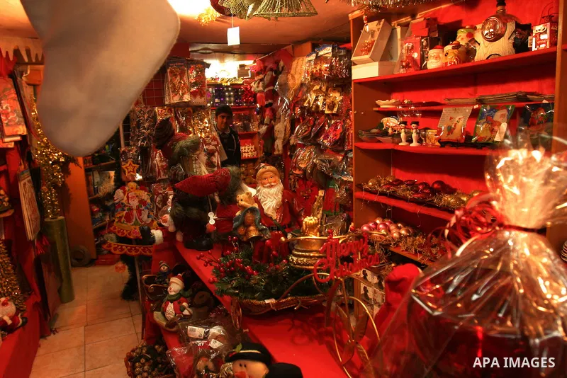 A Palestinian vendor displays gifts for Christmas at his shop in the main market in Jerusalem's old city, 15 December 2011. Christian worshippers began their spiritual preparations ahead of Christmas Eve and tourists fro...
