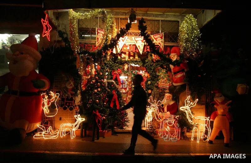 A Palestinian vendor displays gifts for Christmas at his shop in the main market in Jerusalem's old city, 15 December 2011. Christian worshippers began their spiritual preparations ahead of Christmas Eve and tourists fro...