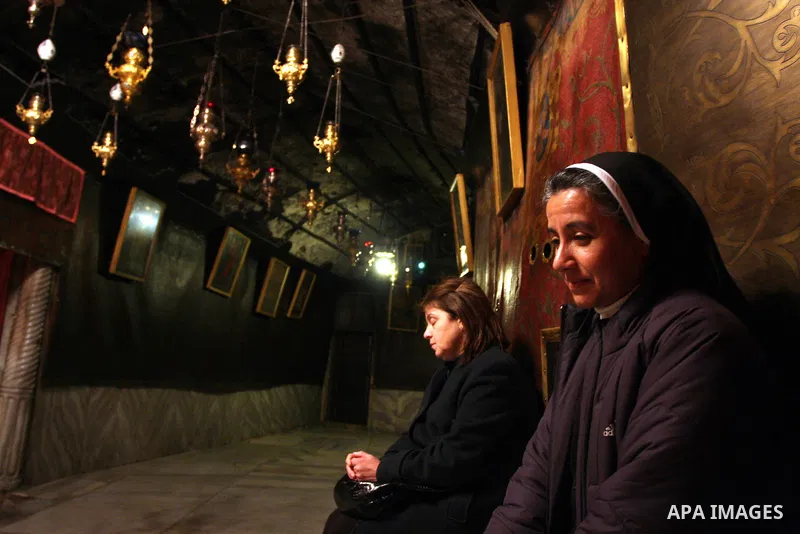 A nun prays at the Grotto of the Church of the Nativity, the traditional birthplace of Jesus Christ, in the West Bank city of Bethlehem December 15, 2011, ahead of Christmas. Christian worshippers began their spiritual p...