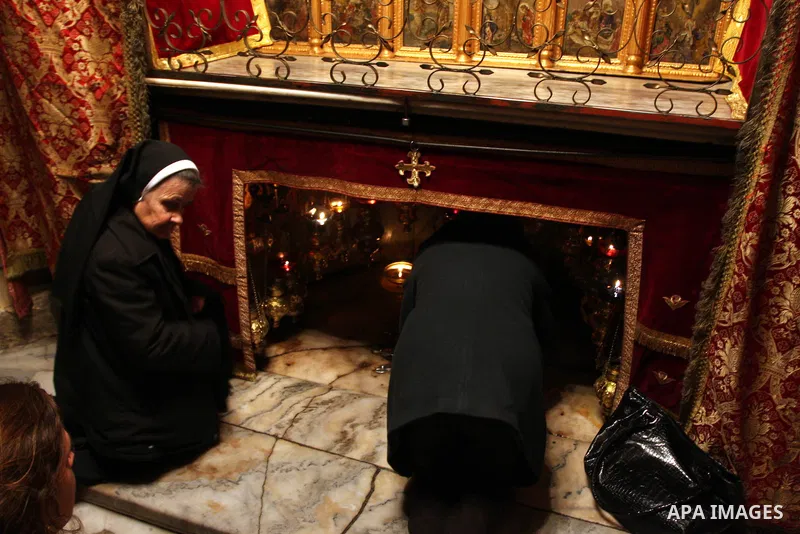 A nun prays at the Grotto of the Church of the Nativity, the traditional birthplace of Jesus Christ, in the West Bank city of Bethlehem December 15, 2011, ahead of Christmas. Christian worshippers began their spiritual p...