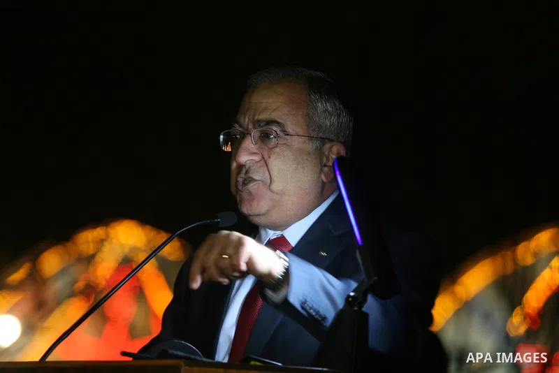 Palestinian prime minister Salam Fayyad watches the lighting of a Christmas tree at Manger Square, outside the Church of the Nativity in West Bank town of Bethlehem,Thursday, Dec. 15, 2011. Christian worshippers began th...