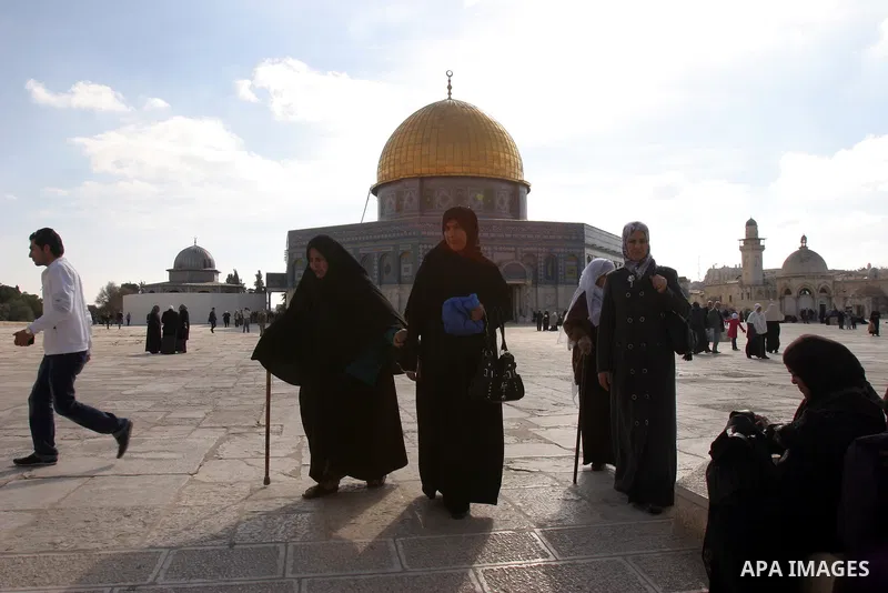 Palestinian Muslims walk in front of the Dome of the Rock after Friday prayers at Al-Aqsa mosque compound in Jerusalem's old city on Dec. 16,2011. Photo by Mahfouz Abu Turk