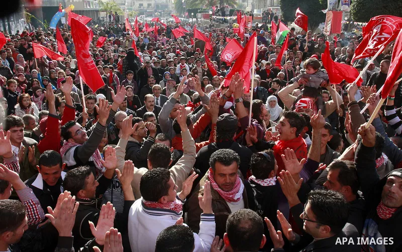 Palestinians wave red flags during a rally to mark the 44th anniversary of the leftist Popular Front for the Liberation of Palestine (PFLP) in the West Bank of Nablus. Saturday , Dec. 17, 2011. Photo by Wagdi Eshtayah.
