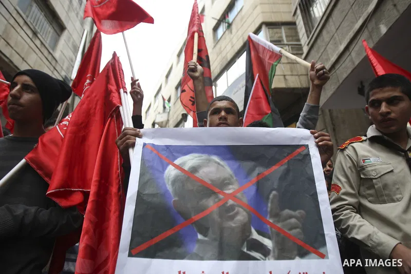 Palestinians hold a poster of U.S republican presidential candidate former House Speaker Newt Gingrich, during a rally marking the 44rd anniversary of the leftist Popular Front for the Liberation of Palestine (PFLP) in t...