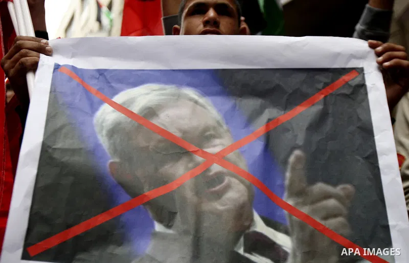 Palestinians hold a poster of U.S republican presidential candidate former House Speaker Newt Gingrich, during a rally marking the 44rd anniversary of the leftist Popular Front for the Liberation of Palestine (PFLP) in t...