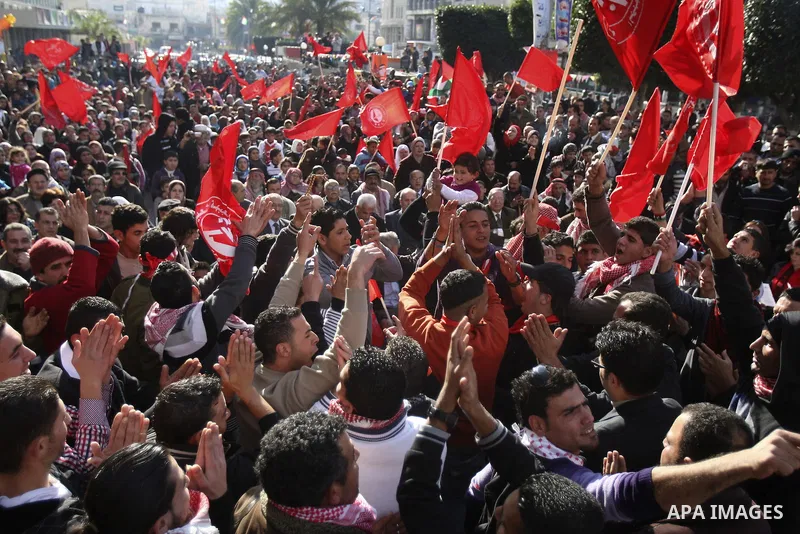 Palestinians wave red flags during a rally to mark the 44th anniversary of the leftist Popular Front for the Liberation of Palestine (PFLP) in the West Bank of Nablus. Saturday , Dec. 17, 2011. Photo by Wagdi Eshtayah.