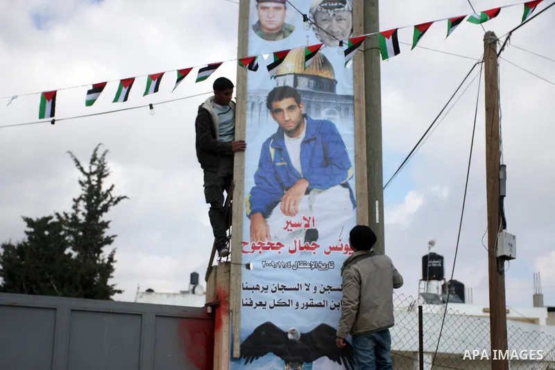 Palestinian relatives of prisoner Younis Jahjouh decorate the street ahead of his release from Israeli prisons in the Qalandia refugee camp near the West Bank city of Ramallah, Saturday, Dec 17, 2011. Israel is set to re...