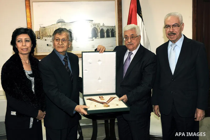 Palestinian President Mahmoud Abbas (Abu Mazen) honors the poet Samih al-Qasim in the West Bank city of Ramallah on Dec. 18, 2011. Photo by Thaer Ganaim