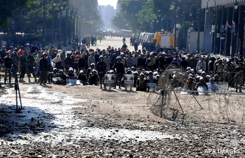 Egyptian protesters throw stones towards security forces during clashes in central Cairo on December 18, 2011 in the third straight day of violence which has left 10 people dead and some 500 wounded. Photo by Ahmed Asad