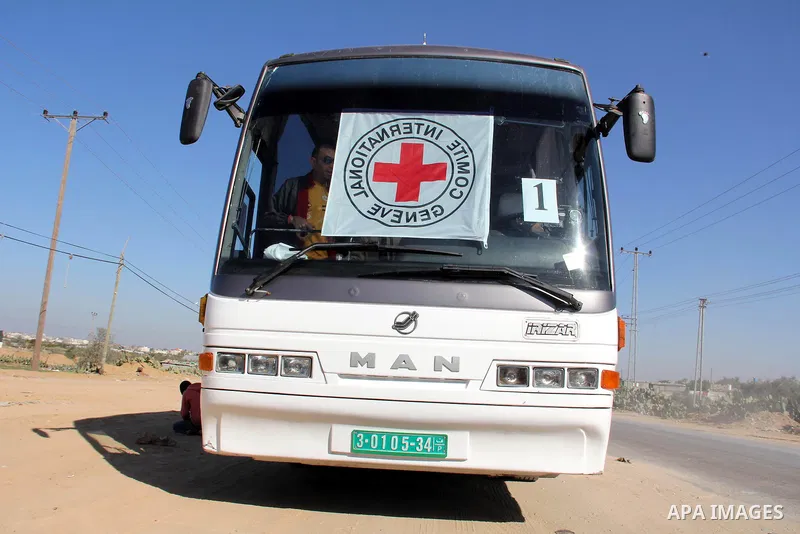 Red Cross vehicles arrive in Rafah border crossing, in southern Gaza Strip, on Dec. 18, 2011. About 40 live in Gaza Strip from the total 550 Palestinian prisoners will be freed on Sunday from Israeli jails, in the second...
