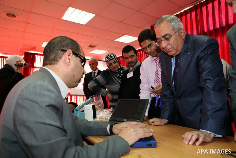 Palestinian Prime Minister Salam Fayyad visits the exhibition organized by Noor Al Ain "the light of eye" Association for the blind and visually impaired in the West Bank city of Ramallah on Dec. 18, 2011. Photo by Musta...