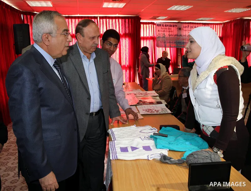 Palestinian Prime Minister Salam Fayyad visits the exhibition organized by Noor Al Ain "the light of eye" Association for the blind and visually impaired in the West Bank city of Ramallah on Dec. 18, 2011. Photo by Musta...