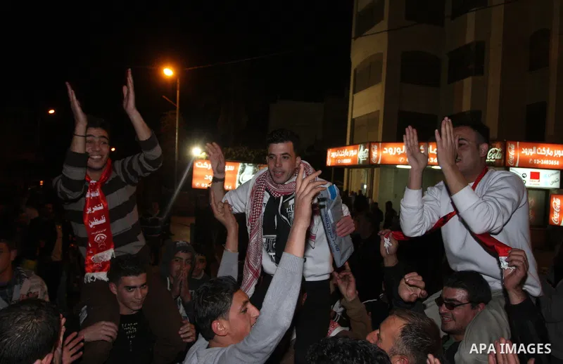 Released Palestinian prisoners celebrate as they arrive to the West Bank city of Ramallah, early Monday, Dec. 19, 2011. Israel released hundreds of Palestinian prisoners late Sunday, the second and final phase of a swap...