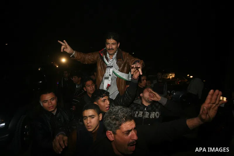 A Palestinian prisoner hugs his relatives as he arrives in Rafah, crossing in southern Gaza strip, after being released on December 18, 2011. Israel today freed 550 Palestinian prisoners, completing the second phase of a...