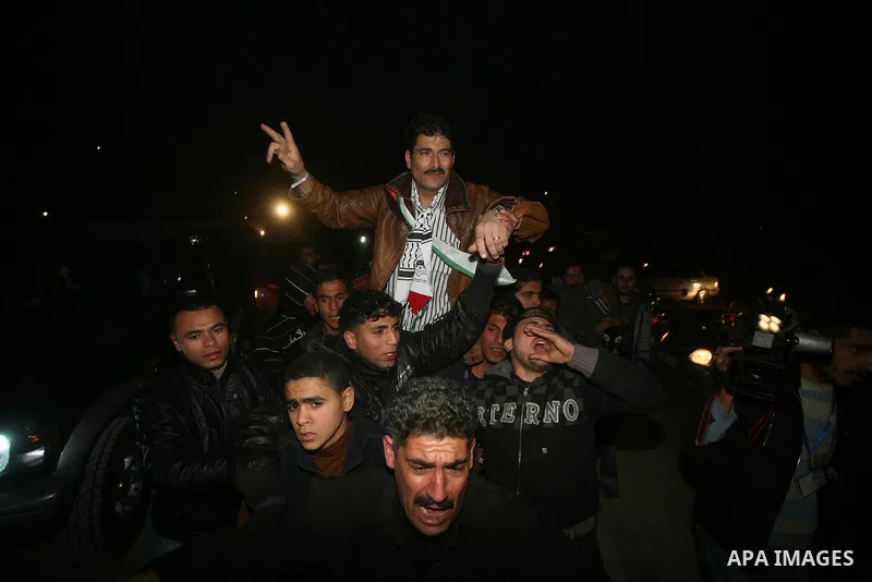 A Palestinian prisoner hugs his relatives as he arrives in Rafah, crossing in southern Gaza strip, after being released on December 18, 2011. Israel today freed 550 Palestinian prisoners, completing the second phase of a...