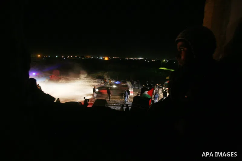 People celebrate as they wait for the release of Palestinian prisoners from Israeli jails at Rafah crossing in the southern Gaza Strip December 18, 2011. Israel plans to release 550 Palestinian prisoners on Sunday in the...