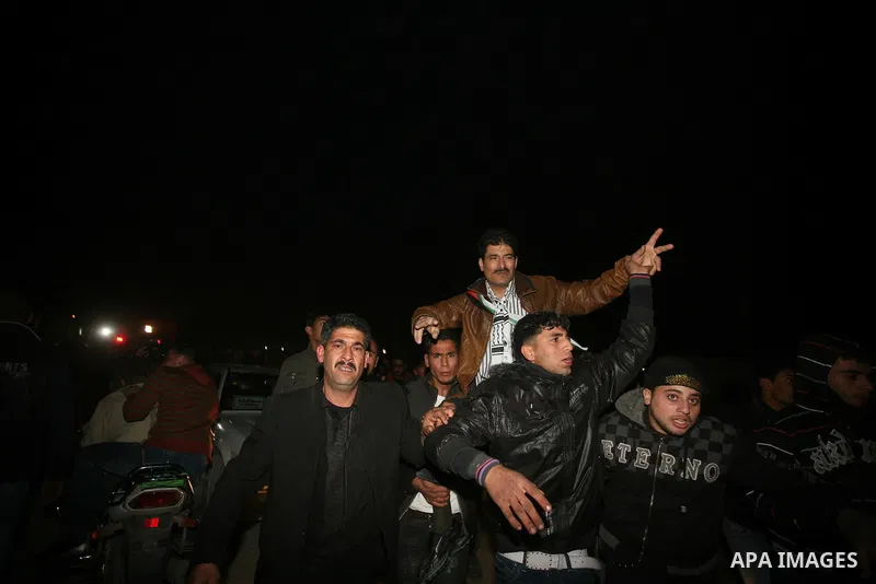 A Palestinian prisoner hugs his relatives as he arrives in Rafah, crossing in southern Gaza strip, after being released on December 18, 2011. Israel today freed 550 Palestinian prisoners, completing the second phase of a...