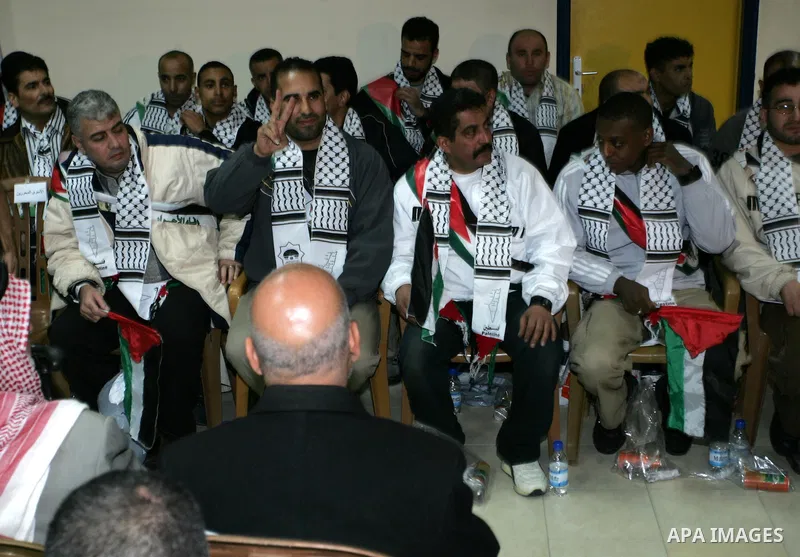 Freed Palestinian prisoners wait to be honored upon arrival at Rafah crossing in the southern Gaza Strip December 18, 2011. Israel plans to release 550 Palestinian prisoners on Sunday in the second stage of a deal with H...