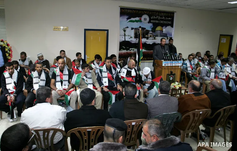 Freed Palestinian prisoners wait to be honored upon arrival at Rafah crossing in the southern Gaza Strip December 18, 2011. Israel plans to release 550 Palestinian prisoners on Sunday in the second stage of a deal with H...
