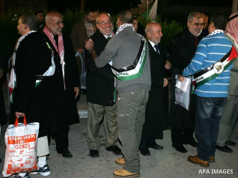 Freed Palestinian prisoners stand in line as they wait to be honored upon arrival at Rafah crossing in the southern Gaza Strip December 18, 2011. Israel plans to release 550 Palestinian prisoners on Sunday in the second...