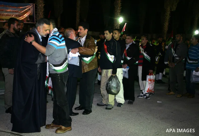 Freed Palestinian prisoners stand in line as they wait to be honored upon arrival at Rafah crossing in the southern Gaza Strip December 18, 2011. Israel plans to release 550 Palestinian prisoners on Sunday in the second...