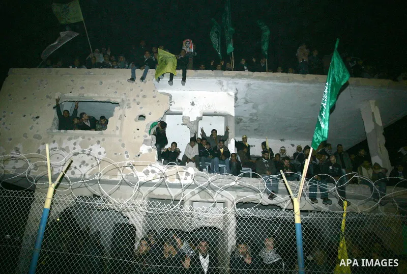 Palestinians celebrate as they wait for the release of Palestinian prisoners in Rafah, crossing in southern Gaza strip, on December 18, 2011. Israel plans to release 550 Palestinian prisoners on Sunday in the second stag...