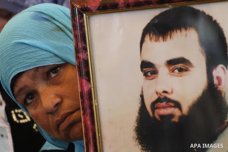 Palestinians women hold pictures of their prisoned relatives in Israeli jails as they gather in a weekly activity calling for their liberty at the Red Cross headquarters in Gaza City on Dec 19, 2011. About 7000 prisoners...