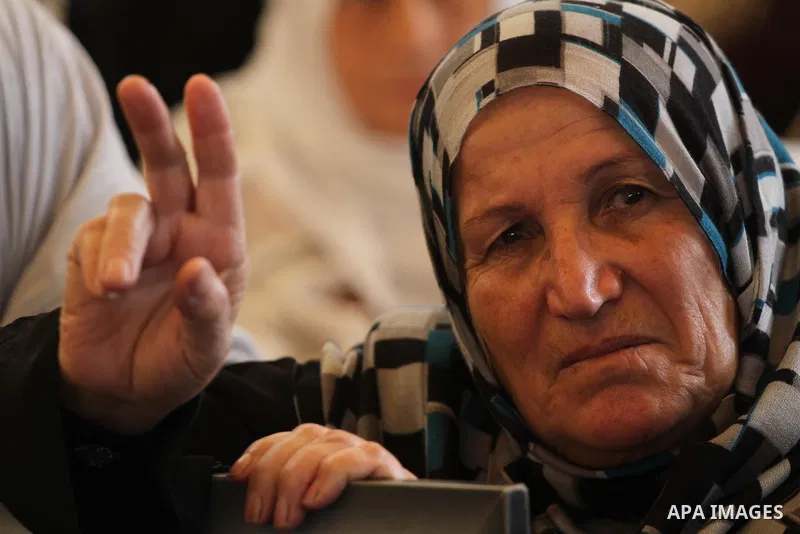 Palestinians women hold pictures of their prisoned relatives in Israeli jails as they gather in a weekly activity calling for their liberty at the Red Cross headquarters in Gaza City on Dec 19, 2011. About 7000 prisoners...