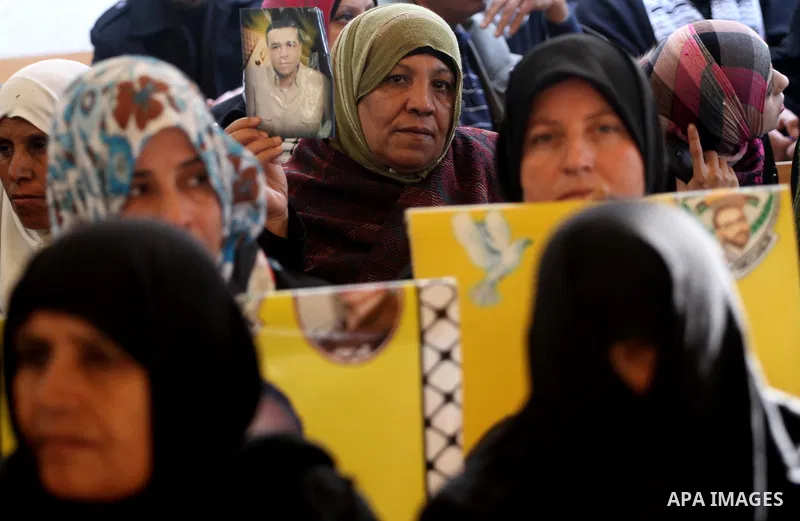 Palestinians women hold pictures of their prisoned relatives in Israeli jails as they gather in a weekly activity calling for their liberty at the Red Cross headquarters in Gaza City on Dec 19, 2011. About 7000 prisoners...
