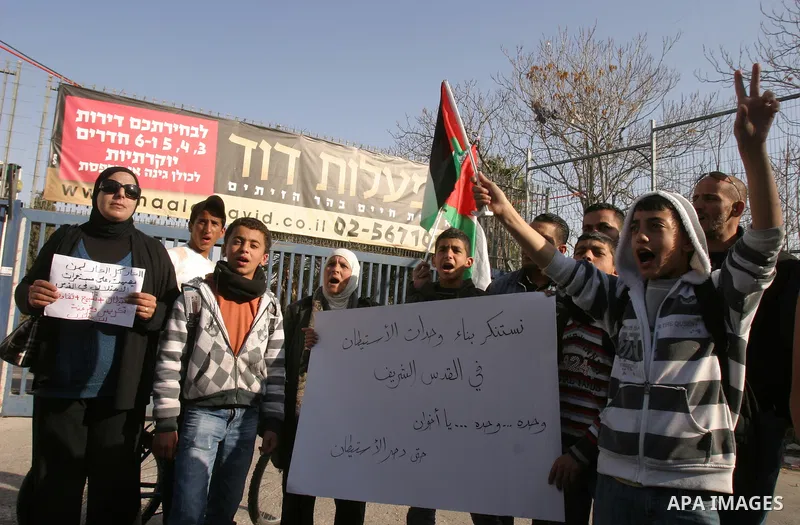 Palestinians, Israelis and foreign activists take part in a protest to show solidarity with Palestinian families against a Jewish settlement in Ras El Amoud neighbourhood in East Jerusalem on Dec 20, 2011. Photo by Mahfo...