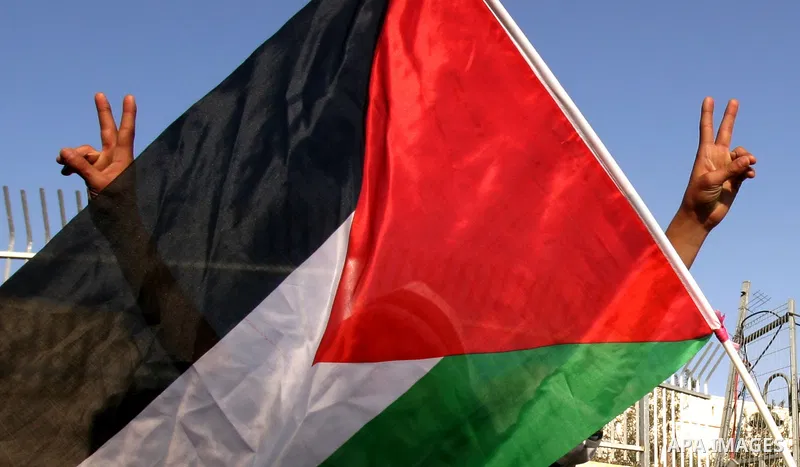 Palestinians, Israelis and foreign activists take part in a protest to show solidarity with Palestinian families against a Jewish settlement in Ras El Amoud neighbourhood in East Jerusalem on Dec 20, 2011. Photo by Mahfo...