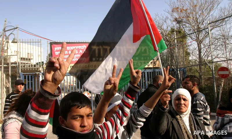 Palestinians, Israelis and foreign activists take part in a protest to show solidarity with Palestinian families against a Jewish settlement in Ras El Amoud neighbourhood in East Jerusalem on Dec 20, 2011. Photo by Mahfo...