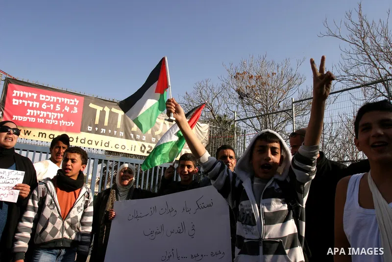 Palestinians, Israelis and foreign activists take part in a protest to show solidarity with Palestinian families against a Jewish settlement in Ras El Amoud neighbourhood in East Jerusalem on Dec 20, 2011. Photo by Mahfo...