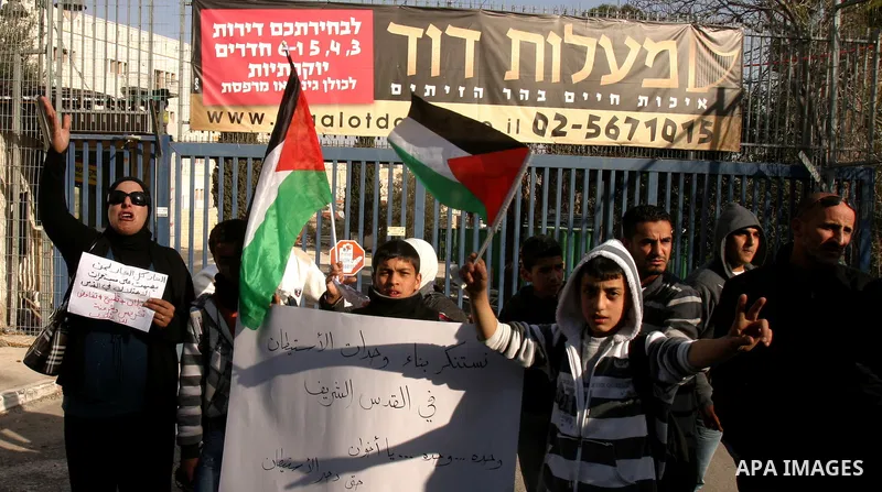 Palestinians, Israelis and foreign activists take part in a protest to show solidarity with Palestinian families against a Jewish settlement in Ras El Amoud neighbourhood in East Jerusalem on Dec 20, 2011. Photo by Mahfo...