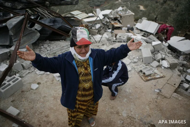 Palestinians inspect a house which was demolished by Israeli army in the occupied West Bank city of Nablus on December 21, 2011. Photo by Wagdi Eshtayah.