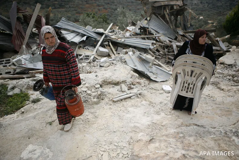 Palestinians inspect a house which was demolished by Israeli army in the occupied West Bank city of Nablus on December 21, 2011. Photo by Wagdi Eshtayah.