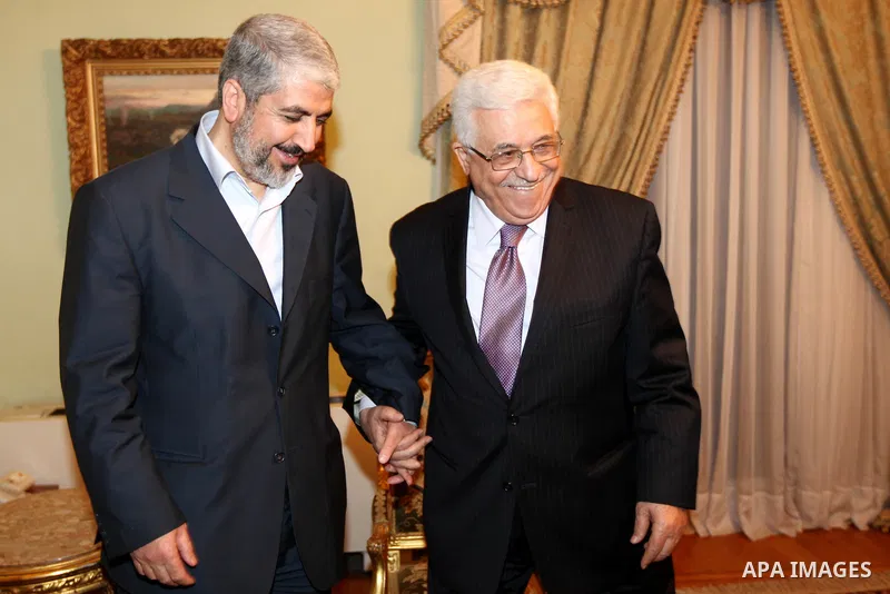 Palestinian President, Mahmoud Abbas (Abu Mazen), shaking hands with the exiled leader of the Palestinian Islamist movement Hamas, Khaled Meshaal, during their meeting in Cairo on December 21, 2011. Palestinian factions,...