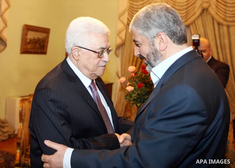 Palestinian President, Mahmoud Abbas (Abu Mazen), shaking hands with the exiled leader of the Palestinian Islamist movement Hamas, Khaled Meshaal, during their meeting in Cairo on December 21, 2011. Palestinian factions,...