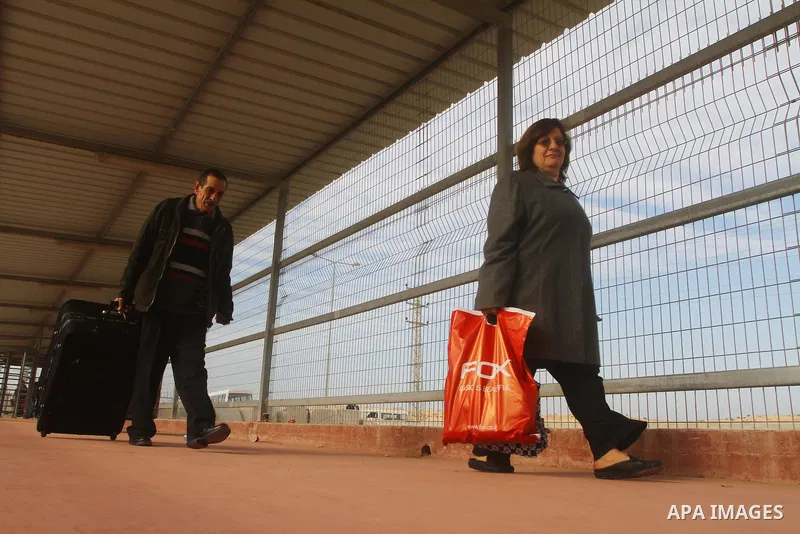 A Christian Palestinian family leaves Gaza to enter Israel through the Erez border crossing between Israel and northern Gaza Strip on Dec. 22,2011. The Israeli army on Thursday allowed some 550 Christian Palestinians to...