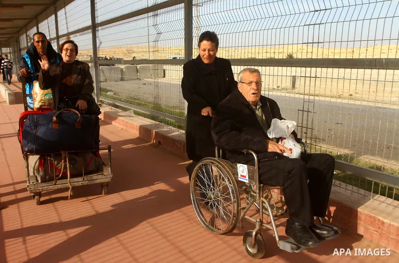 A Christian Palestinian family leaves Gaza to enter Israel through the Erez border crossing between Israel and northern Gaza Strip on Dec. 22,2011. The Israeli army on Thursday allowed some 550 Christian Palestinians to...