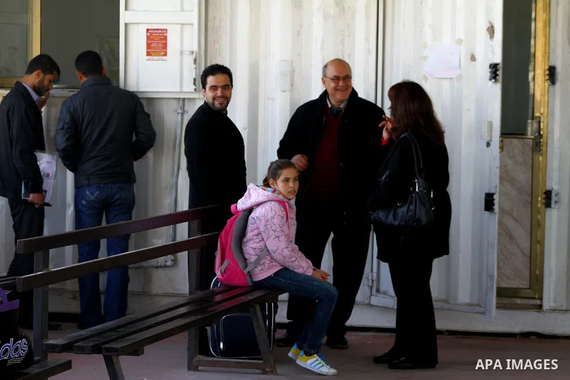 A Christian Palestinian family leaves Gaza to enter Israel through the Erez border crossing between Israel and northern Gaza Strip on Dec. 22,2011. The Israeli army on Thursday allowed some 550 Christian Palestinians to...