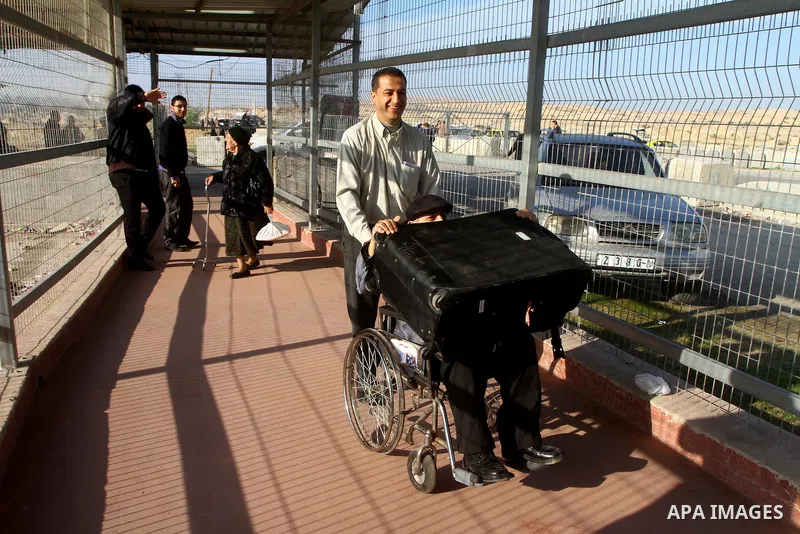 A Christian Palestinian family leaves Gaza to enter Israel through the Erez border crossing between Israel and northern Gaza Strip on Dec. 22,2011. The Israeli army on Thursday allowed some 550 Christian Palestinians to...