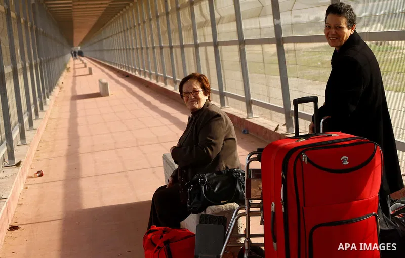 A Christian Palestinian family leaves Gaza to enter Israel through the Erez border crossing between Israel and northern Gaza Strip on Dec. 22,2011. The Israeli army on Thursday allowed some 550 Christian Palestinians to...