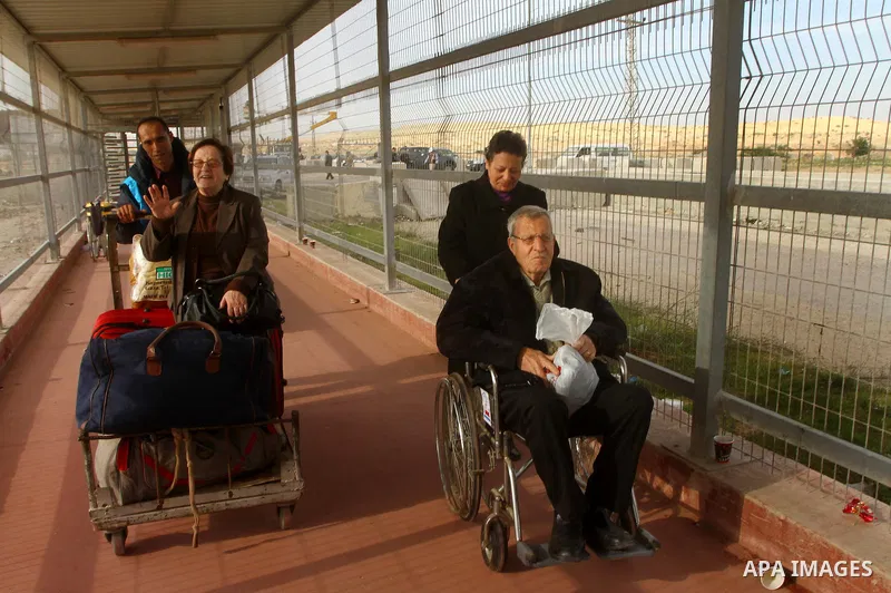 A Christian Palestinian family leaves Gaza to enter Israel through the Erez border crossing between Israel and northern Gaza Strip on Dec. 22,2011. The Israeli army on Thursday allowed some 550 Christian Palestinians to...