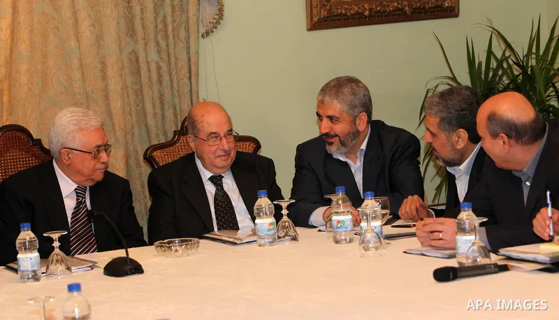 From L to R: Palestinian President Mahmoud Abbas, Salim al-Zanoun, head of Palestinian national council, Hamas leader Khaled Meshaal and Palestinian Islamic Jihad leader, Ramadan Shalah, talk during their meeting in Cair...