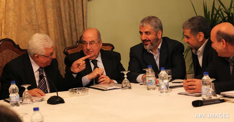 From L to R: Palestinian President Mahmoud Abbas, Salim al-Zanoun, head of Palestinian national council, Hamas leader Khaled Meshaal and Palestinian Islamic Jihad leader, Ramadan Shalah, talk during their meeting in Cair...