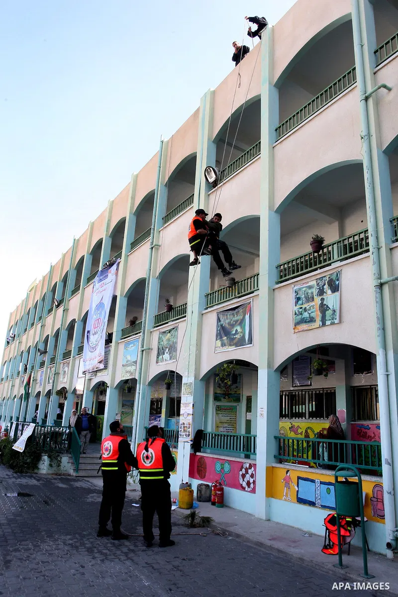 Palestinian schoolgirls take part in a civil defence exercises at a school in Rafah, in the southern of Gaza Strip on December 22, 2011. Photo by Abed Rahim Khatib