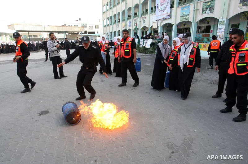 Palestinian schoolgirls take part in a civil defence exercises at a school in Rafah, in the southern of Gaza Strip on December 22, 2011. Photo by Abed Rahim Khatib