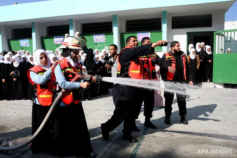 Palestinian schoolgirls take part in a civil defence exercises at a school in Rafah, in the southern of Gaza Strip on December 22, 2011. Photo by Abed Rahim Khatib